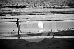 Boy and Dog Running towards Water