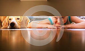 Boy with doggy friend looks under the bed