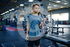 Boy doing exercise with dumbbells, bottom view