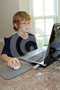 Boy doing homework on computer