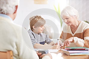 Boy doing homework with grandma