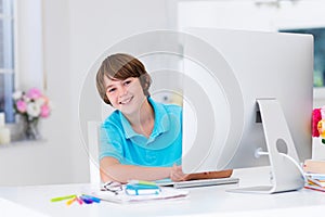 Boy doing homework with modern computer