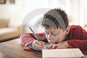 Boy doing homework reluctantly