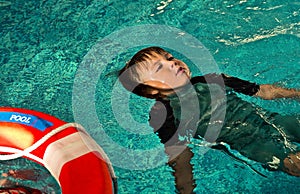Boy doing Lifesaving Floating on Water.