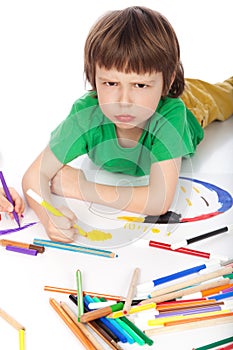 Boy doodling on white paper photo