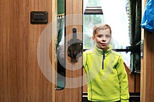 Boy in doorway of train compartment