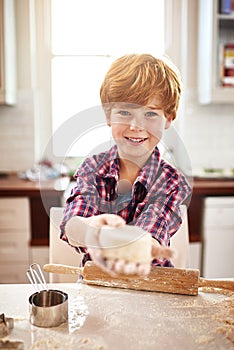 Boy, dough and portrait in kitchen for baking, learning and fun for childhood on holiday indoor. Young child, smile and