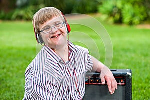 Boy with down syndrome wearing headphones.