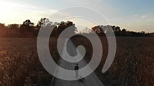 Boy dragging his bicycle behind him