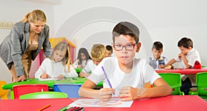 Boy drawing in schoolroom
