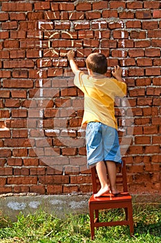 Boy drawing sun and window