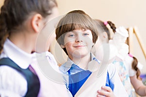 Boy draws in class with other children