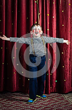 Boy Dressed as Clown Performing on Stage