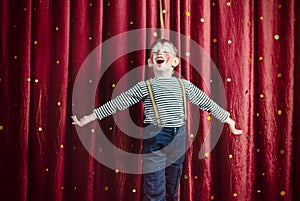 Boy Dressed as Clown Performing on Stage