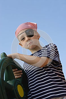 Boy Dressed As Pirate Holding A Steering Wheel