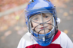 Boy dressed to be the goalie in a street hockey game