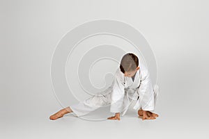 Boy dressed in a white karate kimono