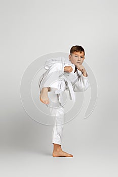 Boy dressed in a white karate kimono