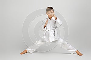 Boy dressed in a white karate kimono