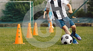 Boy Dribble a Soccer Ball Between Cones. Football Training Class For Kids