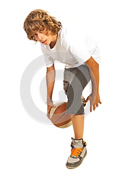 Boy dribbling basketball photo