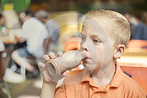 Boy drinking chocolate milk during lunch at his school cafeteria