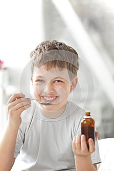 boy drinking cough syrup