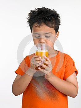 Boy drinking a glass of juic