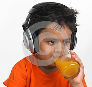 Boy drinking juice with headphone