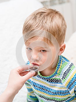 Boy drinking liquid medicine