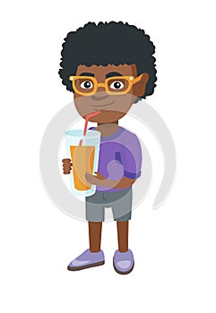 Boy drinking orange juice through a straw.