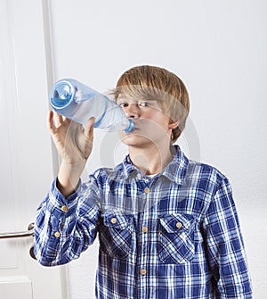 Boy drinking water out of a bottle