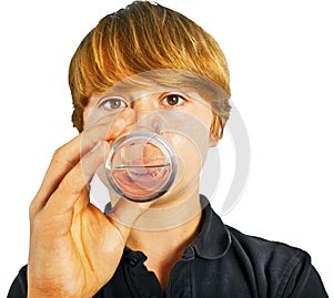 Boy drinking water out of a glass