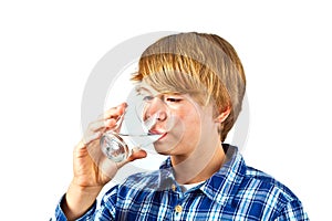Boy drinking water out of a glass