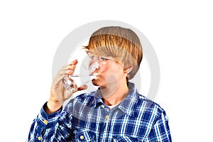 Boy drinking water out of a glass