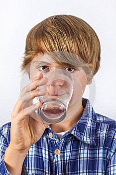 Boy drinking water out of a glass