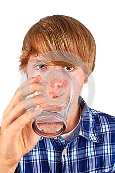 Boy drinks water out of a glass