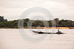 Boy driving boat on Amazon river
