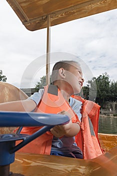 Boy driving boat