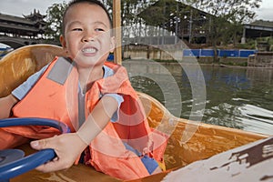 Boy driving boat