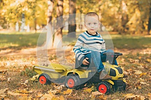 Boy driving a toy truck in park