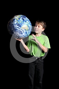 Boy Earth in his hand looks with wonder fascinatio