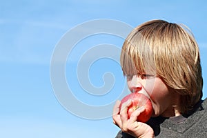 Boy eating an apple