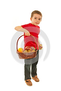 Boy eating apple from basket