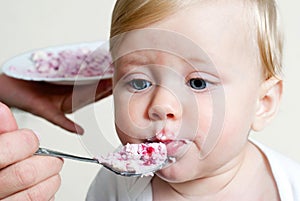 Boy eating baby food with spoon