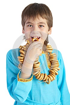 The boy eating a bread ring over white