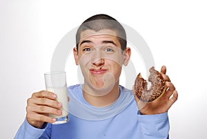 Boy eating chocolate donuts.