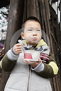 Boy eating congee