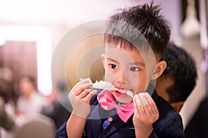 A boy is eating food.