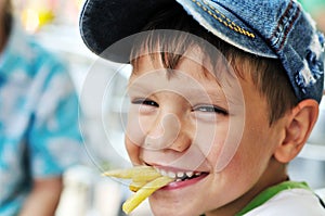 Boy eating french fries